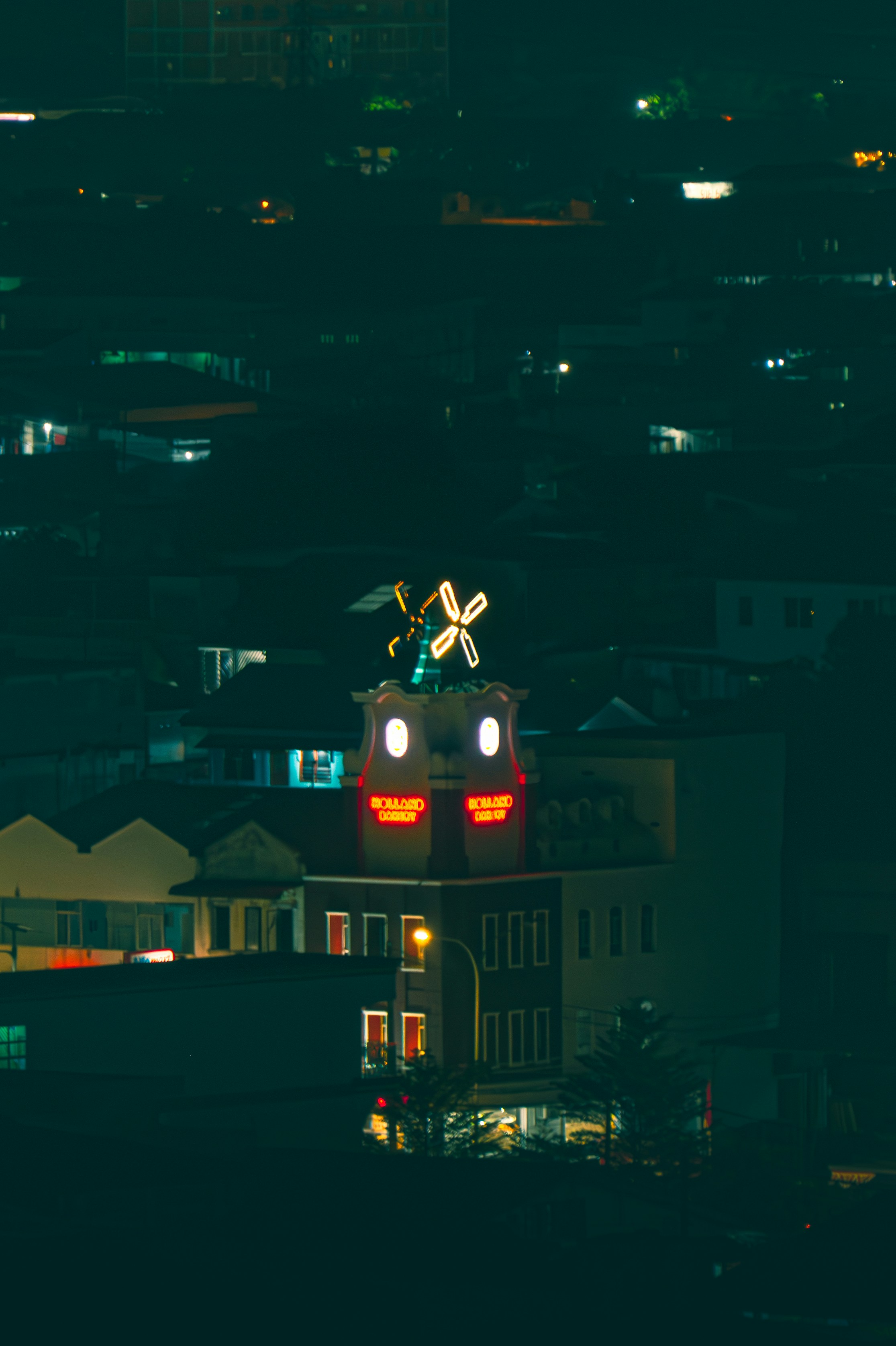 Illuminated building with clock tower at night