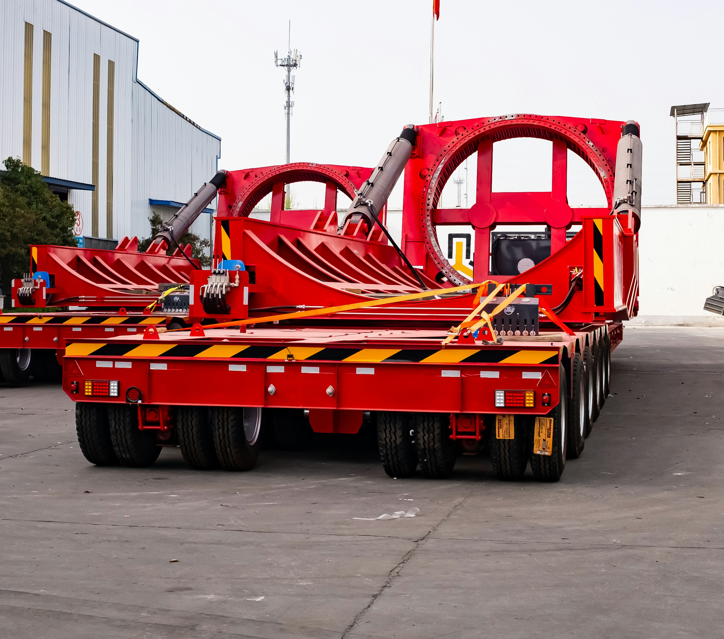 Red heavy-duty trailers with large circular openings.