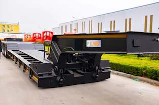 A black heavy-duty trailer parked outdoors