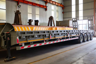 A long, flatbed trailer with multiple wheels.
