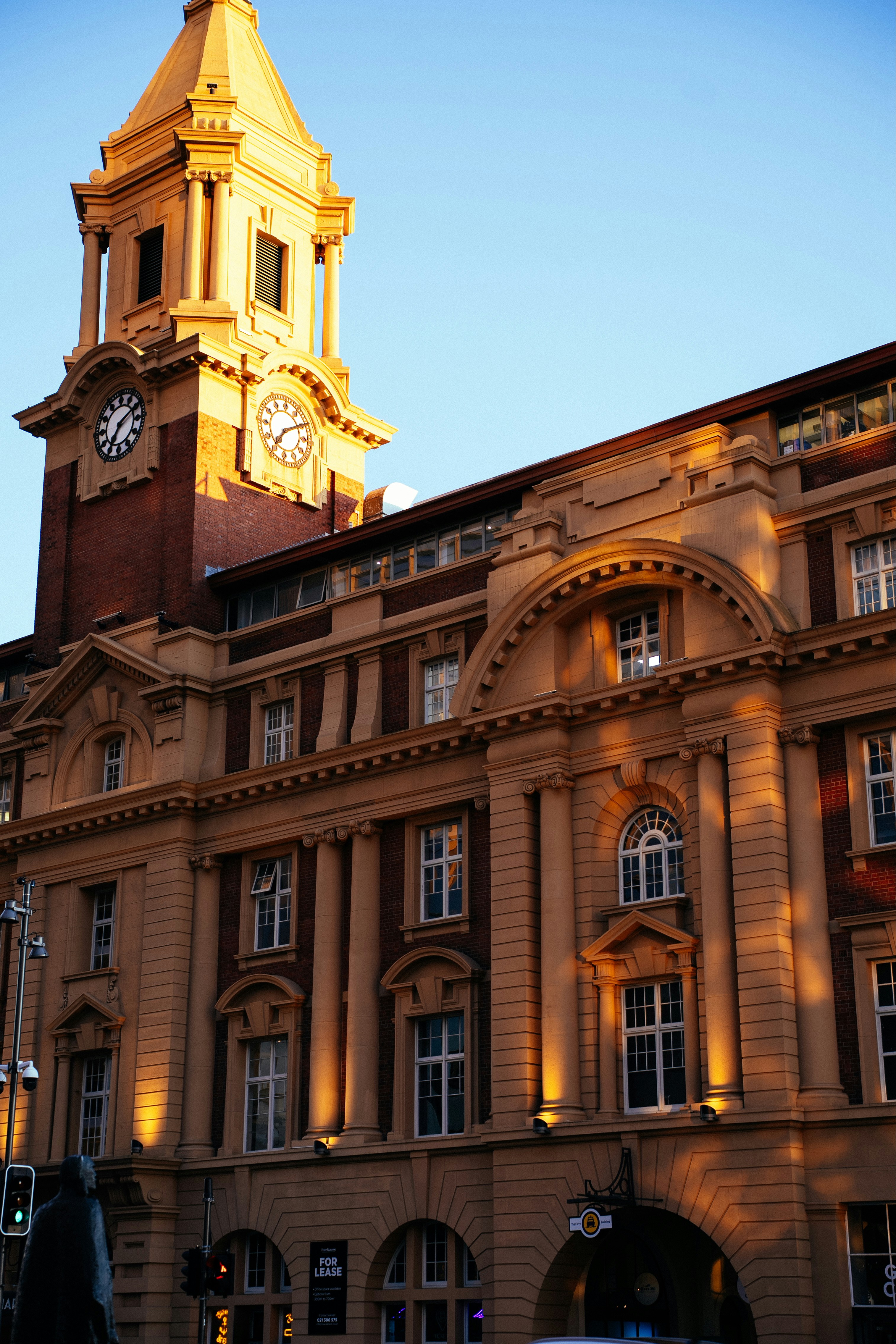 Ornate building with a clock tower at sunset