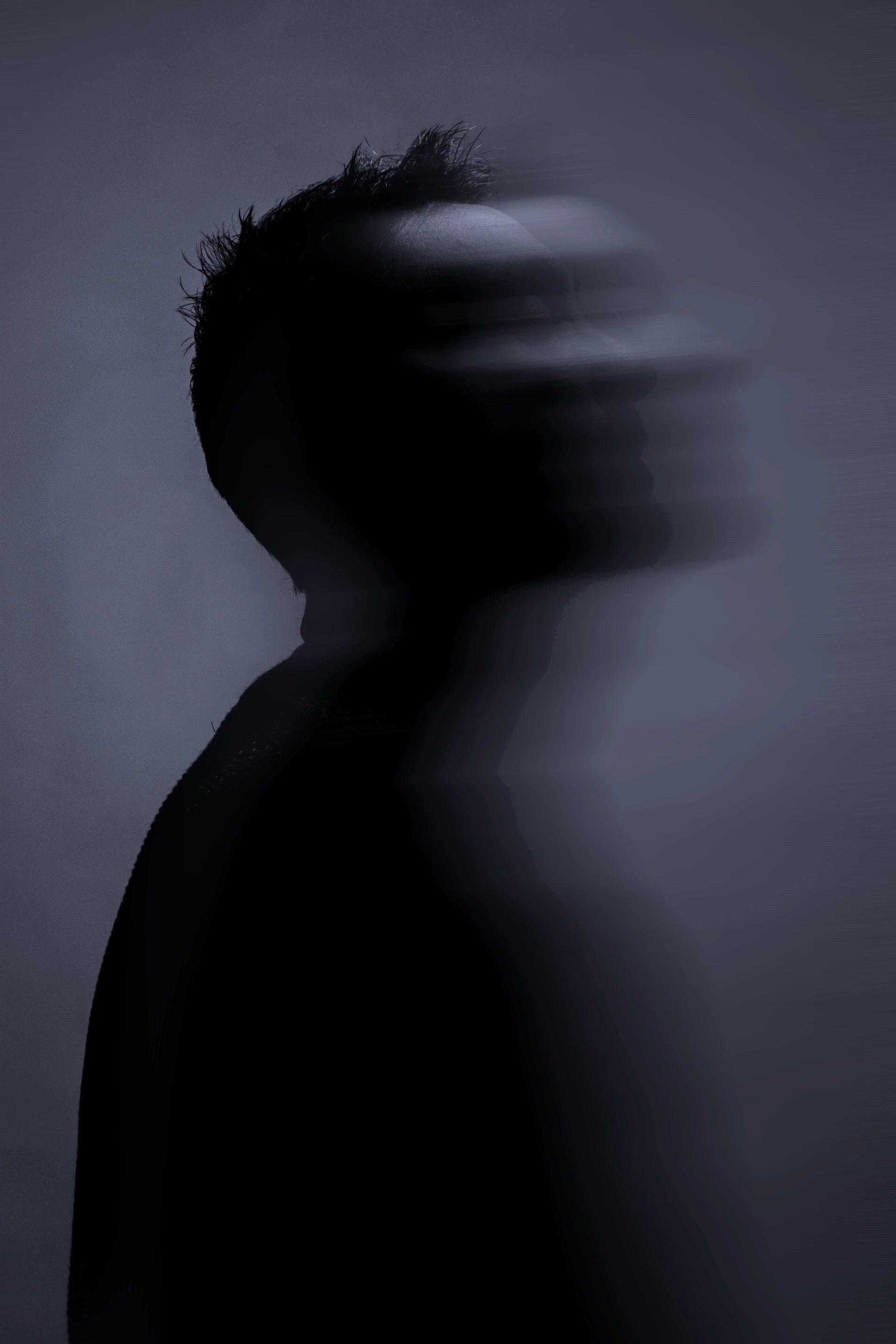Silhouette of a person with blurred face in profile.