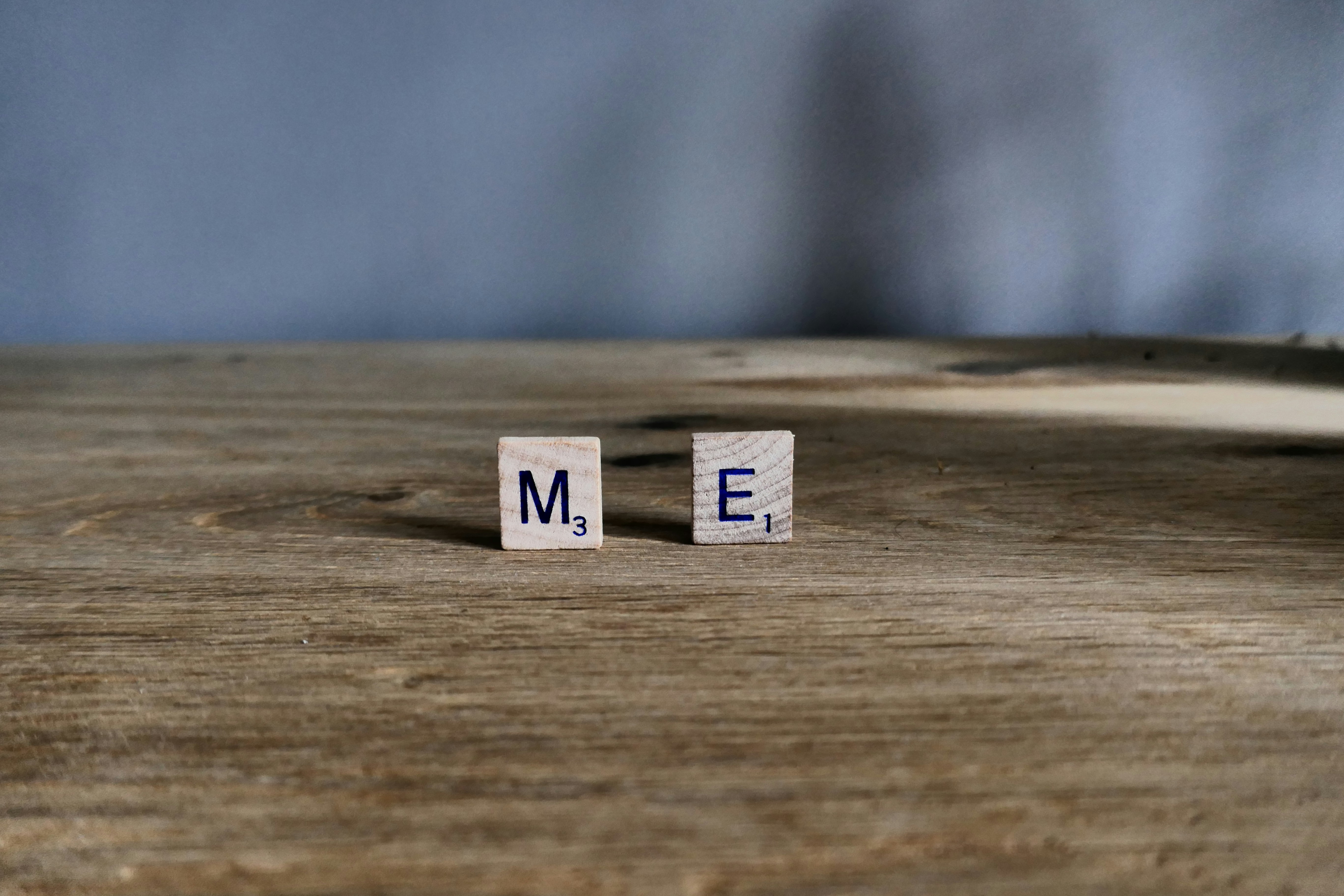 Scrabble tiles spelling out M E