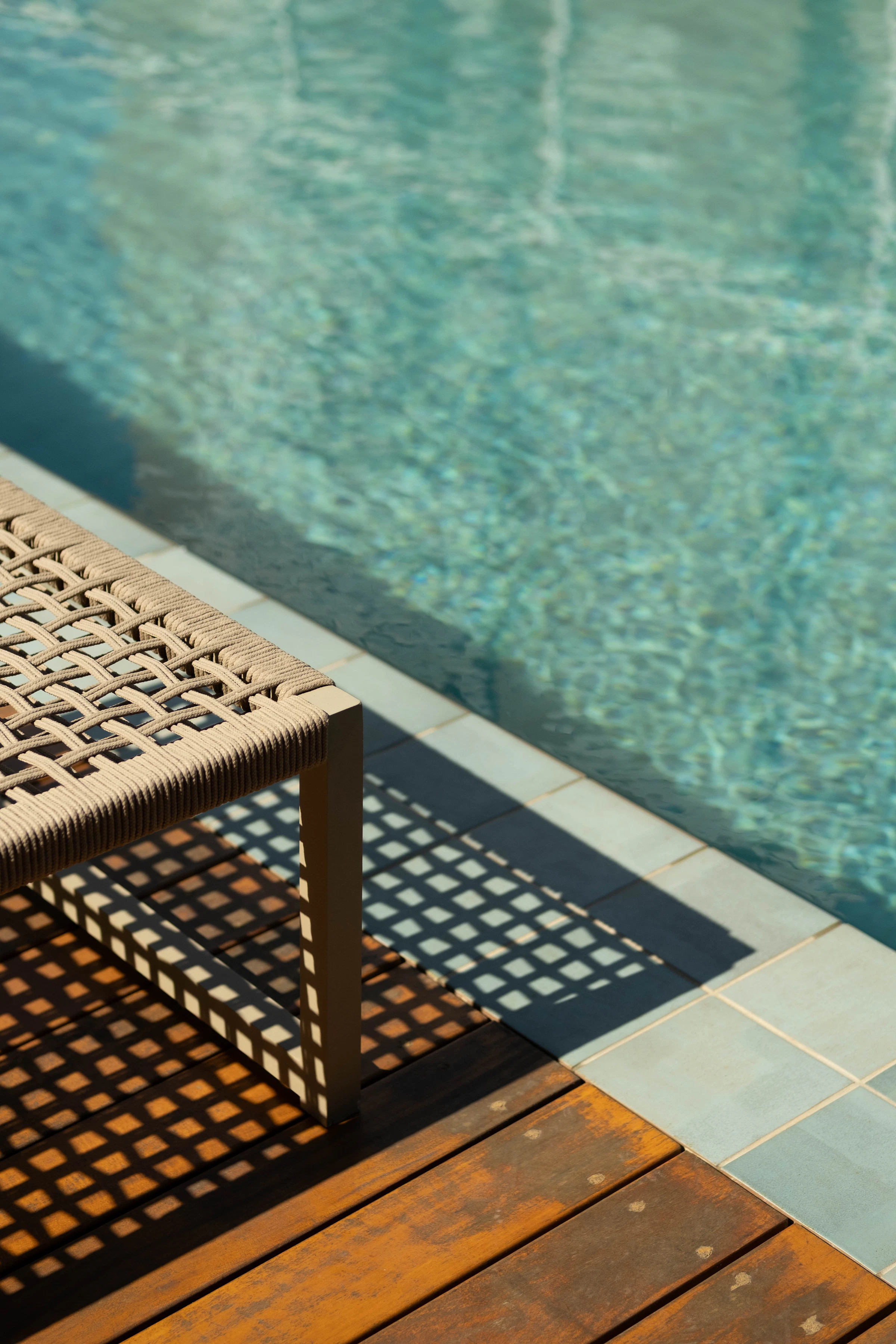 Late afternoon light and long shadows beside a pool