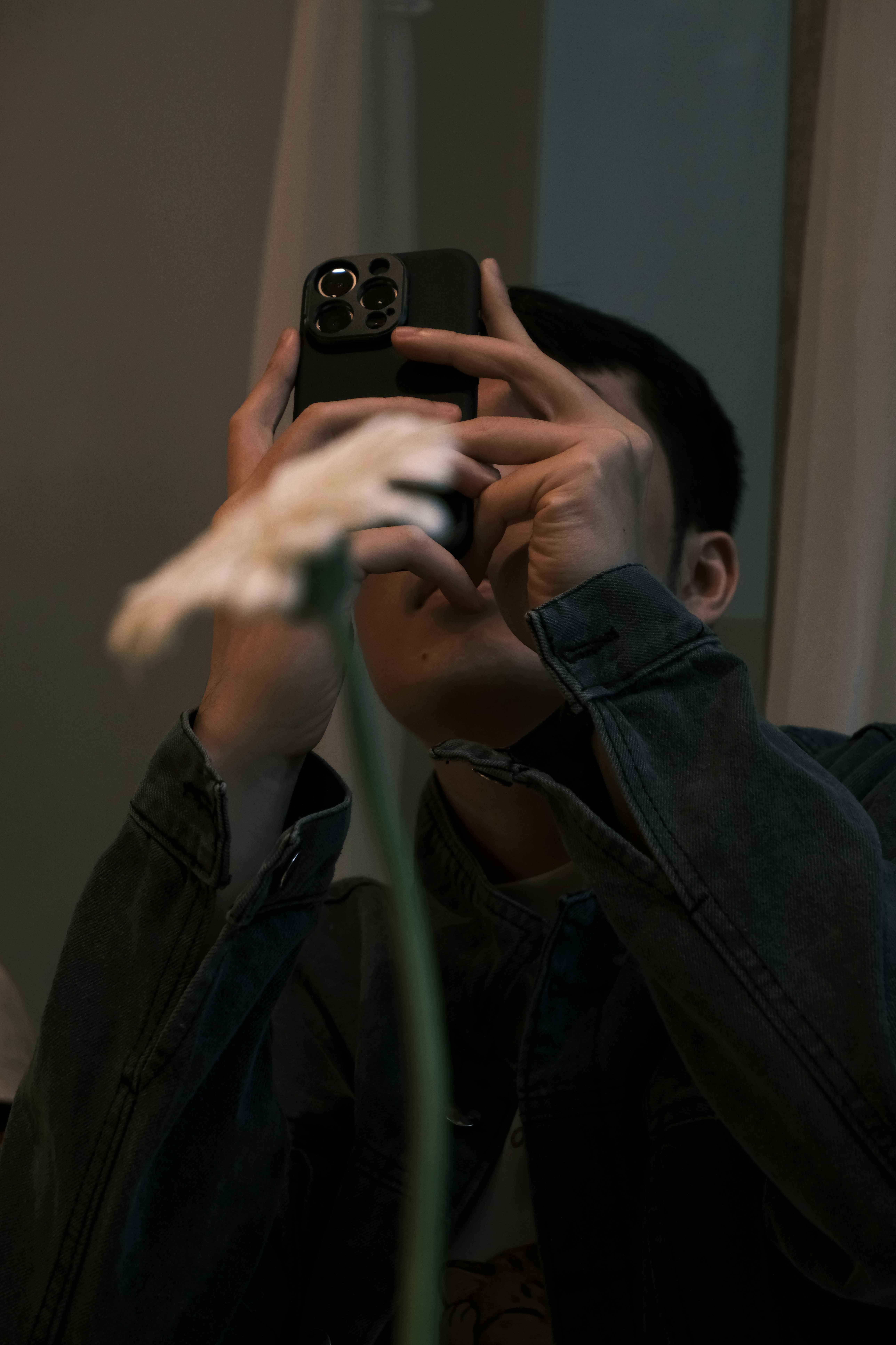 Person taking a picture of a flower with phone