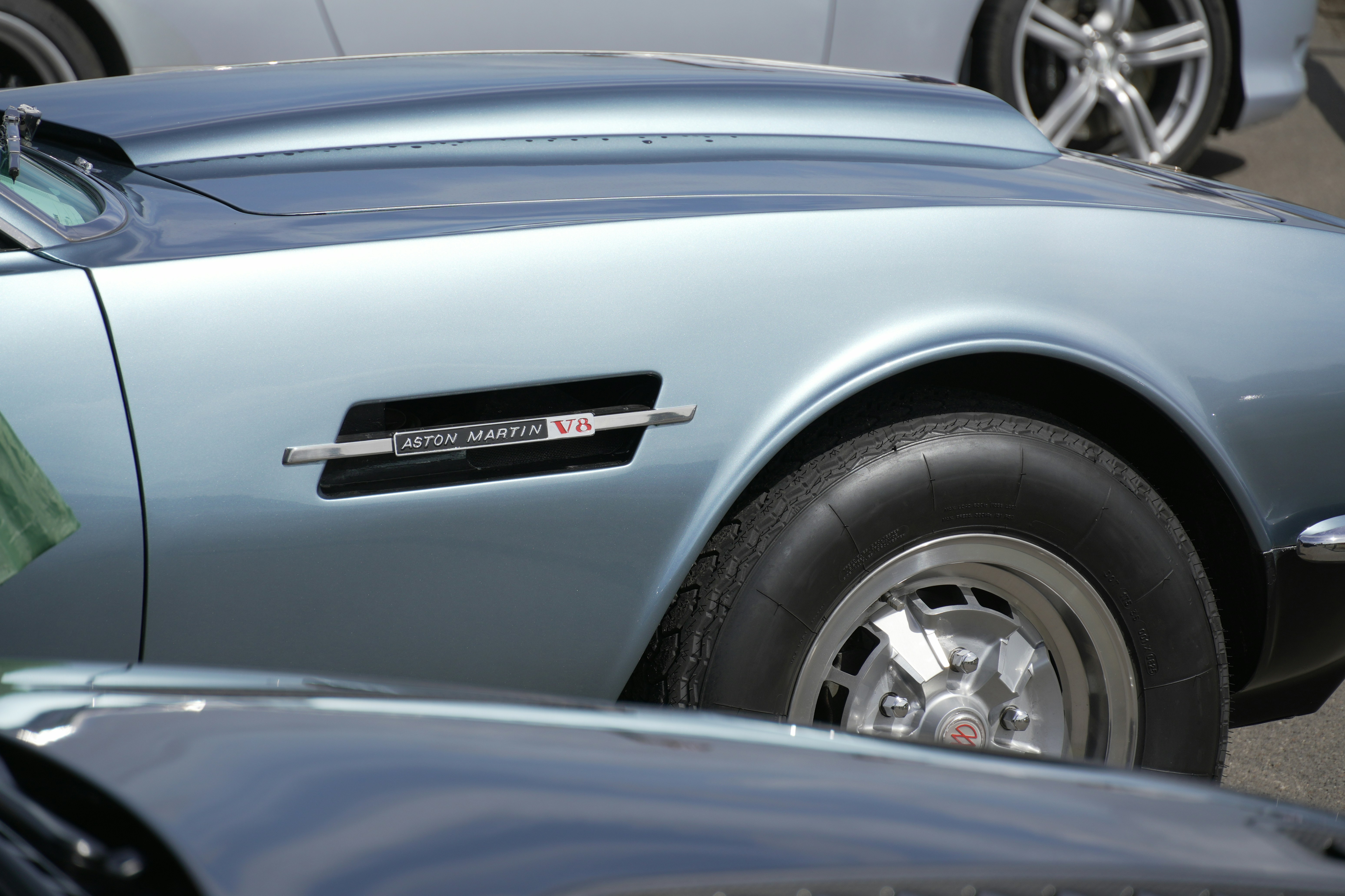 Close-up of a vintage light blue car fender.