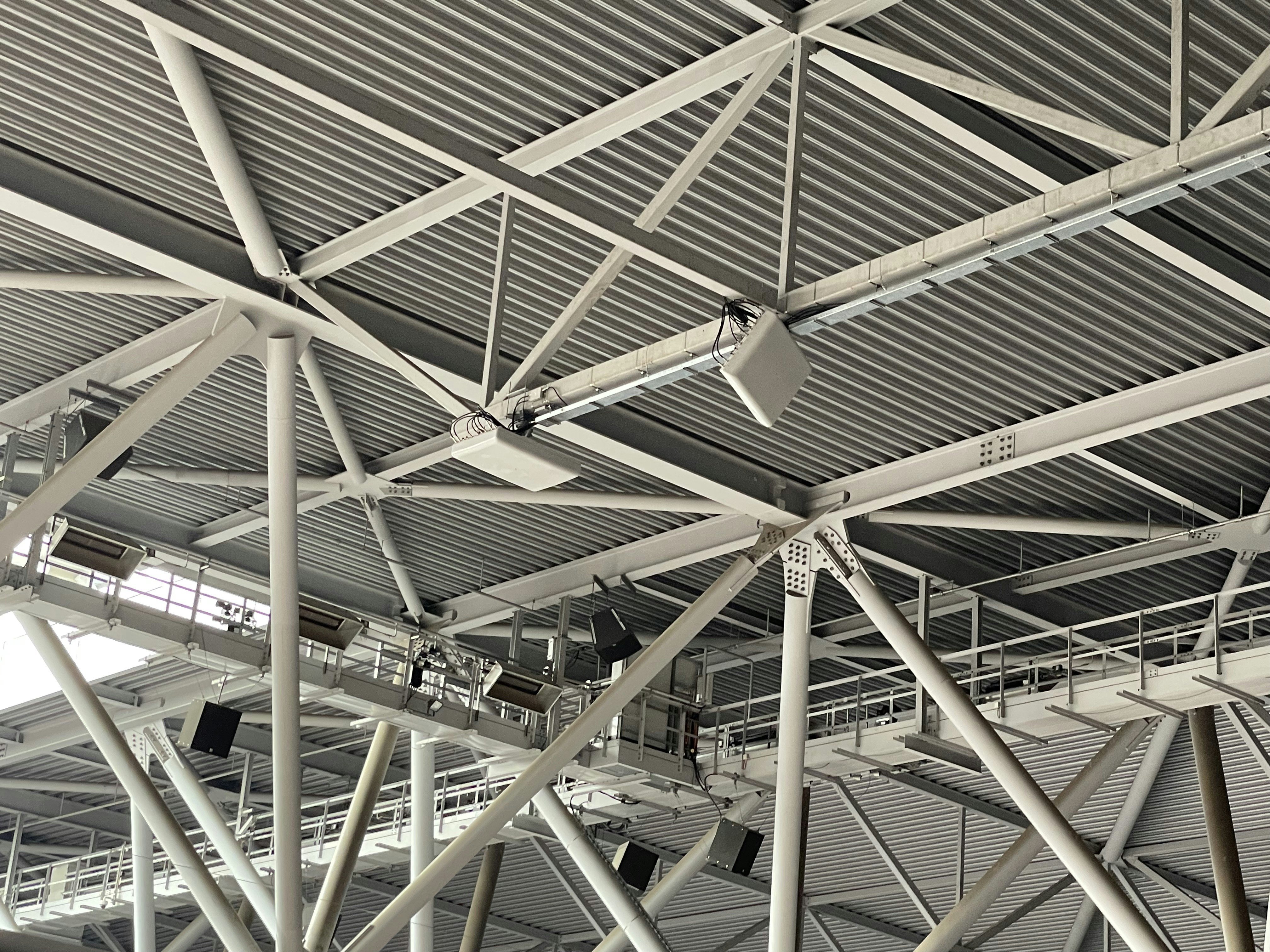 Modern industrial metal ceiling structure with beams.
