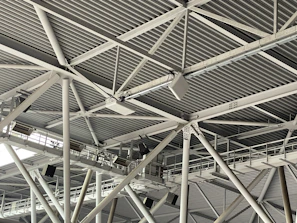 Modern industrial metal ceiling structure with beams.