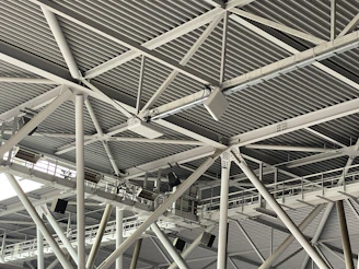 Modern industrial metal ceiling structure with beams.