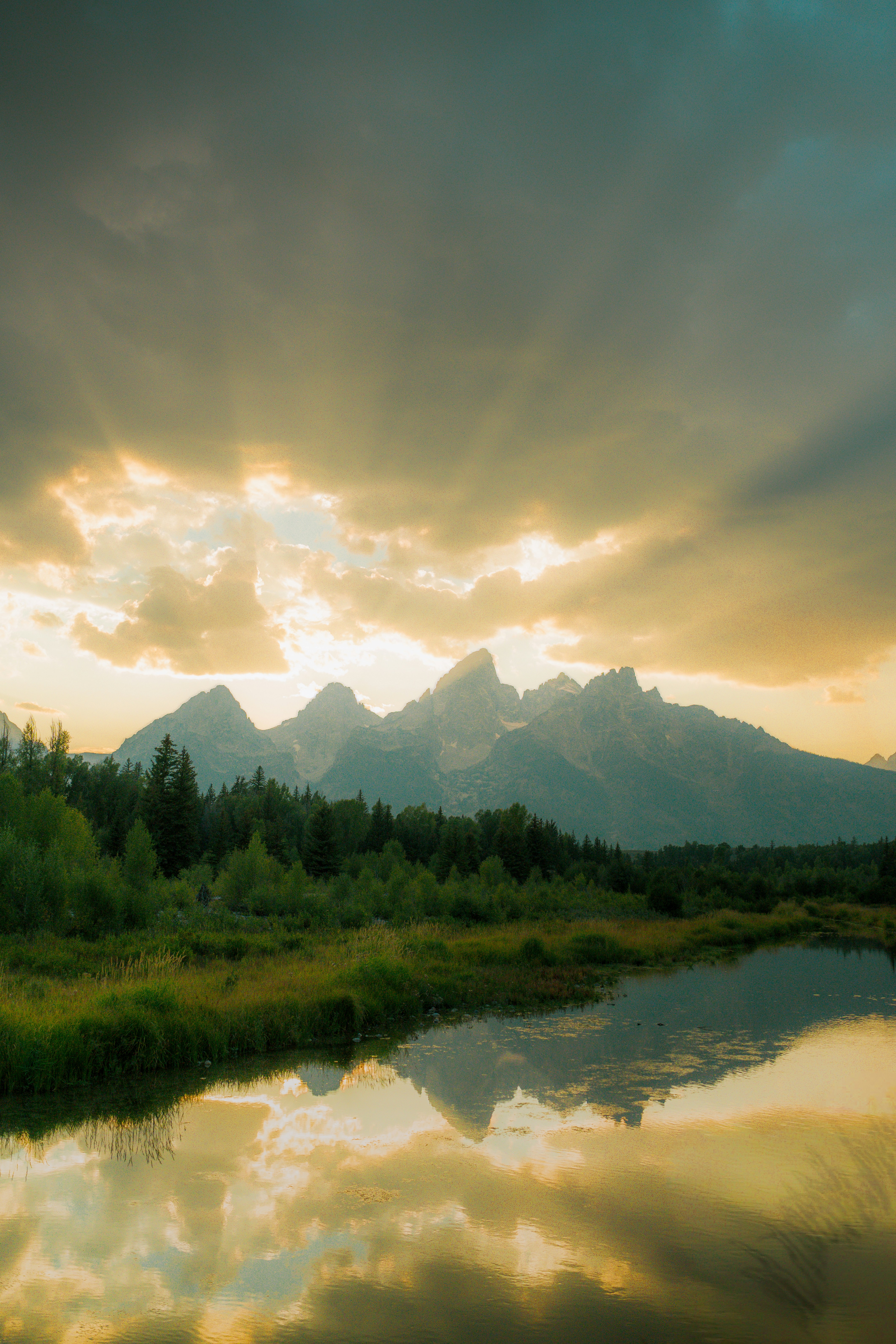 Dramatic sunset over majestic mountains and reflective lake