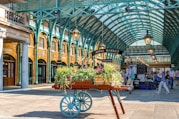 Cart with plants in a market under arched roof