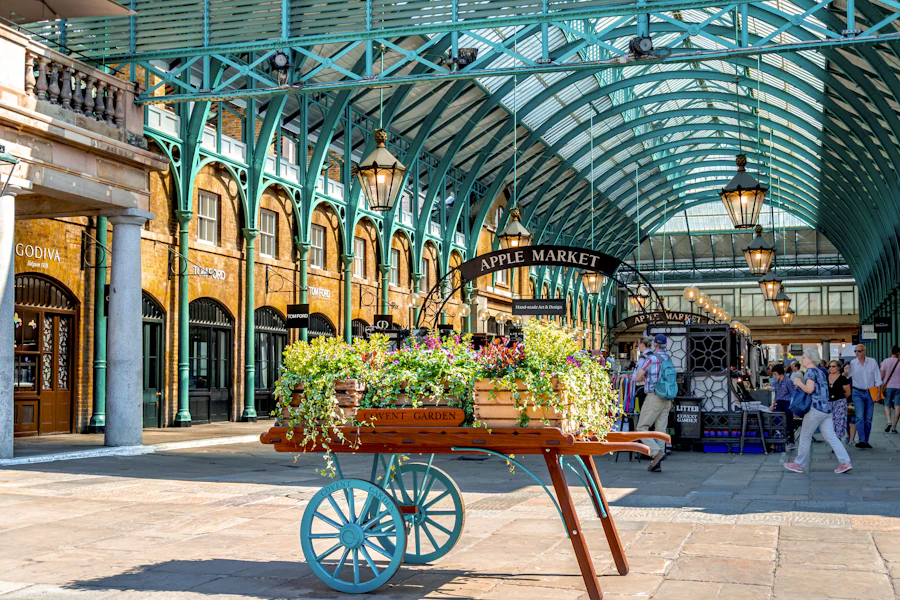 A flower cart beneath the covered roof of Covent Garden Apple Market