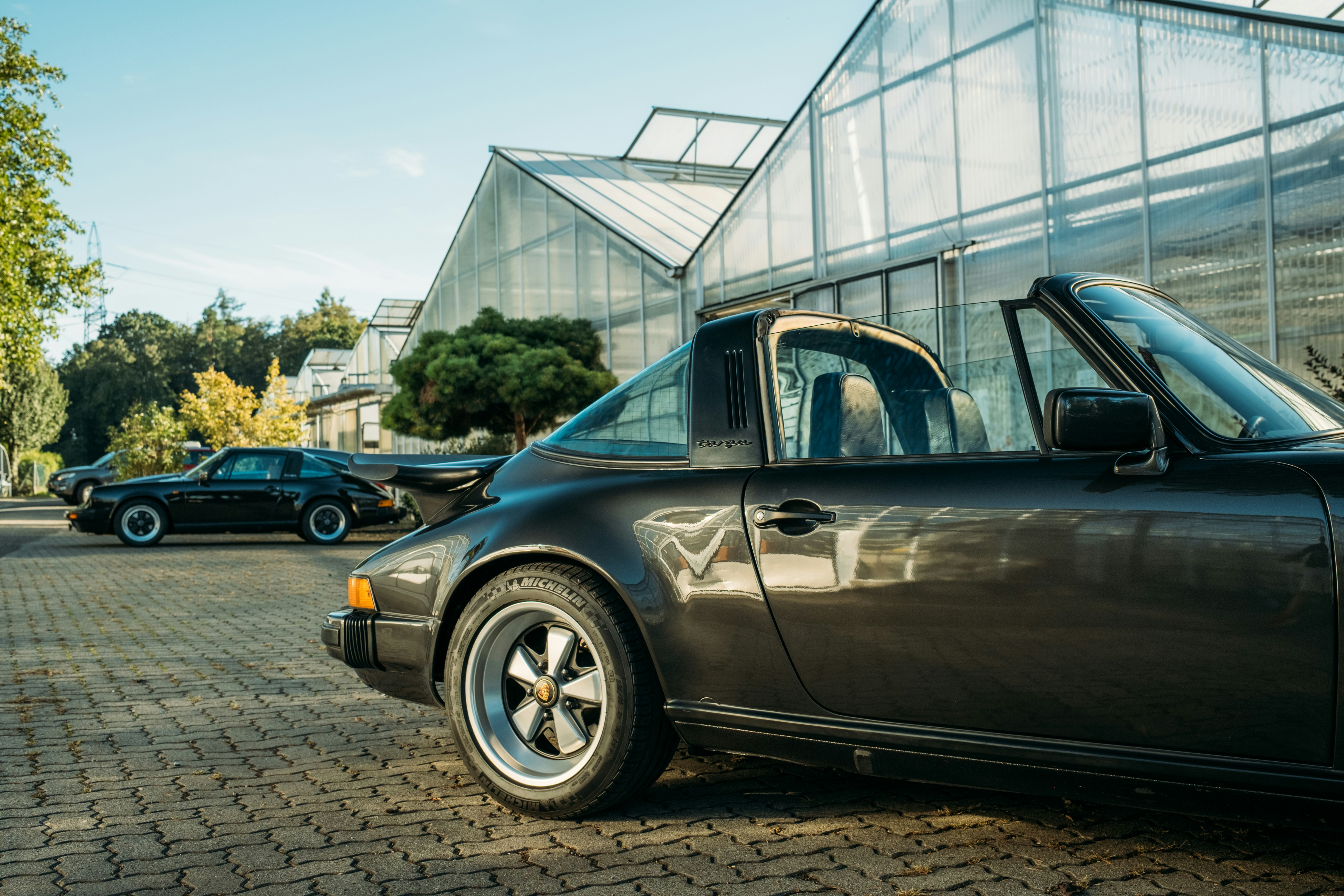 Two classic porsche cars parked outdoors