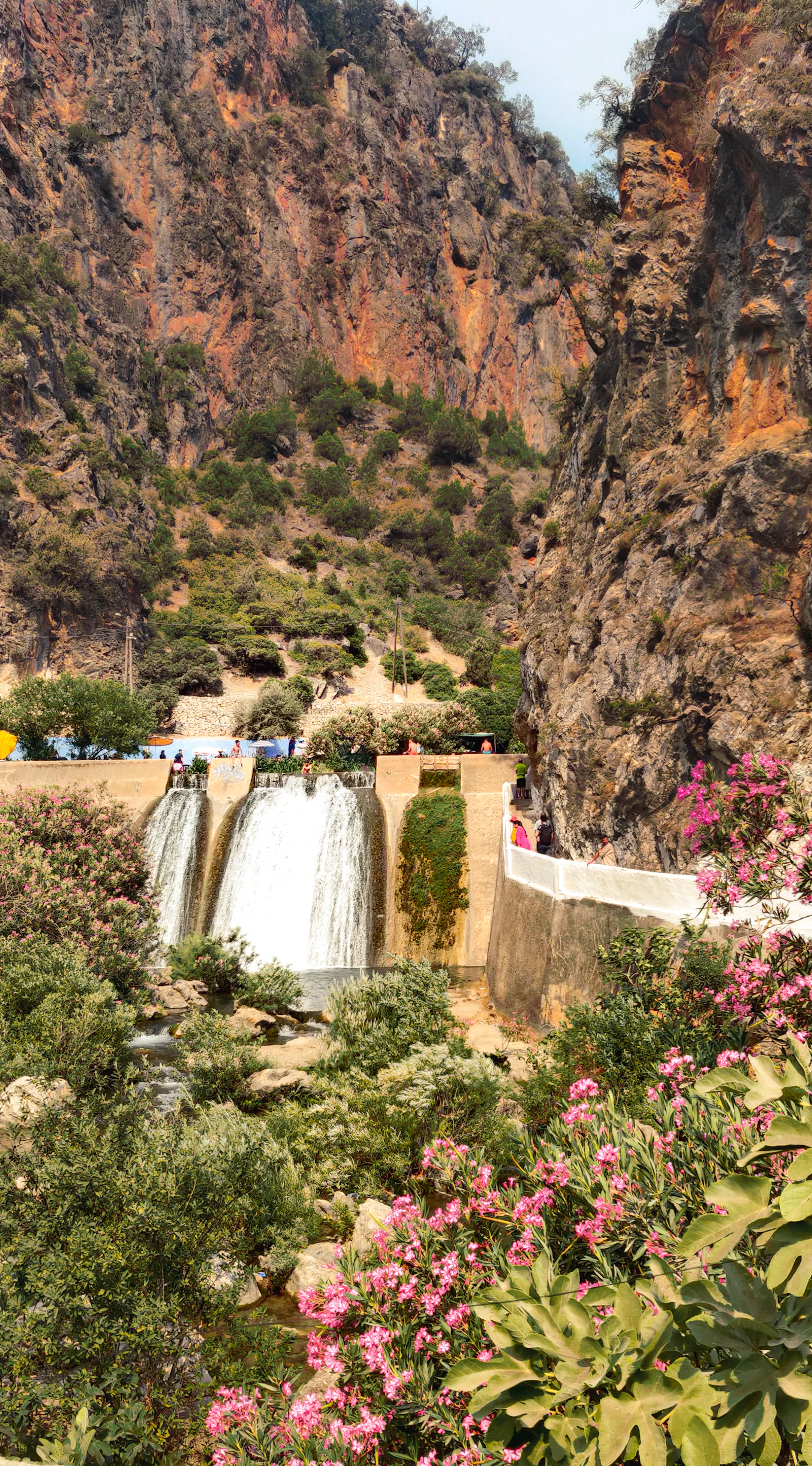 Waterfalls flowing between rocky cliffs