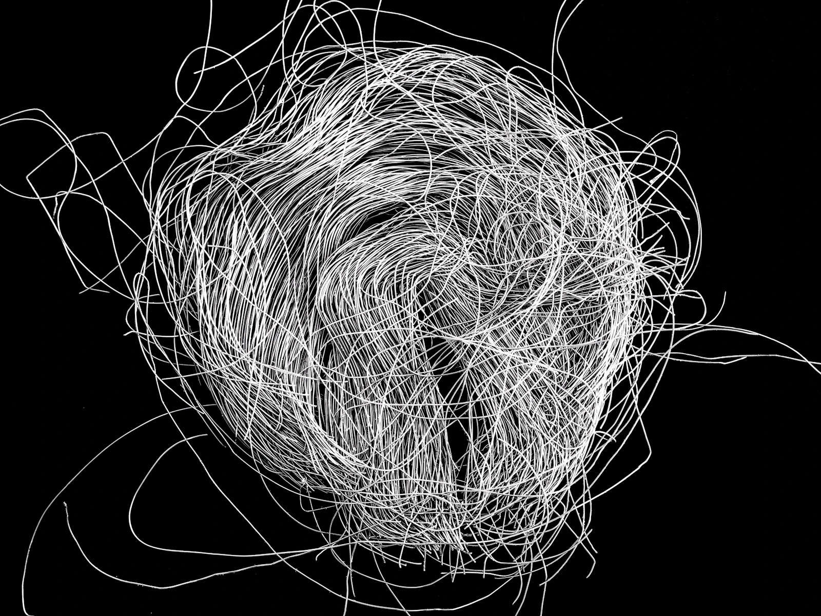 A tangled mess of white cables against a black background