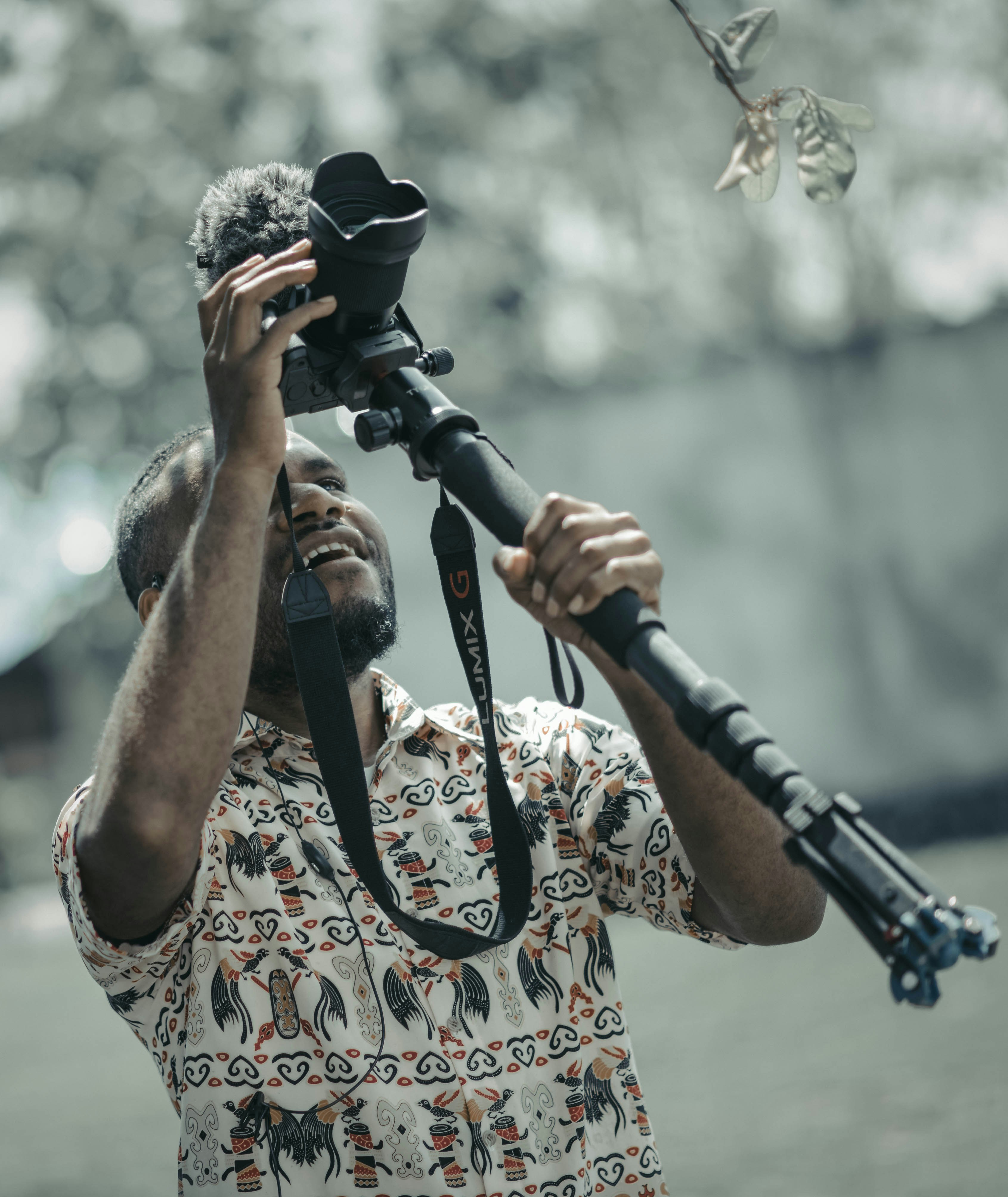 Man with camera on tripod looking up