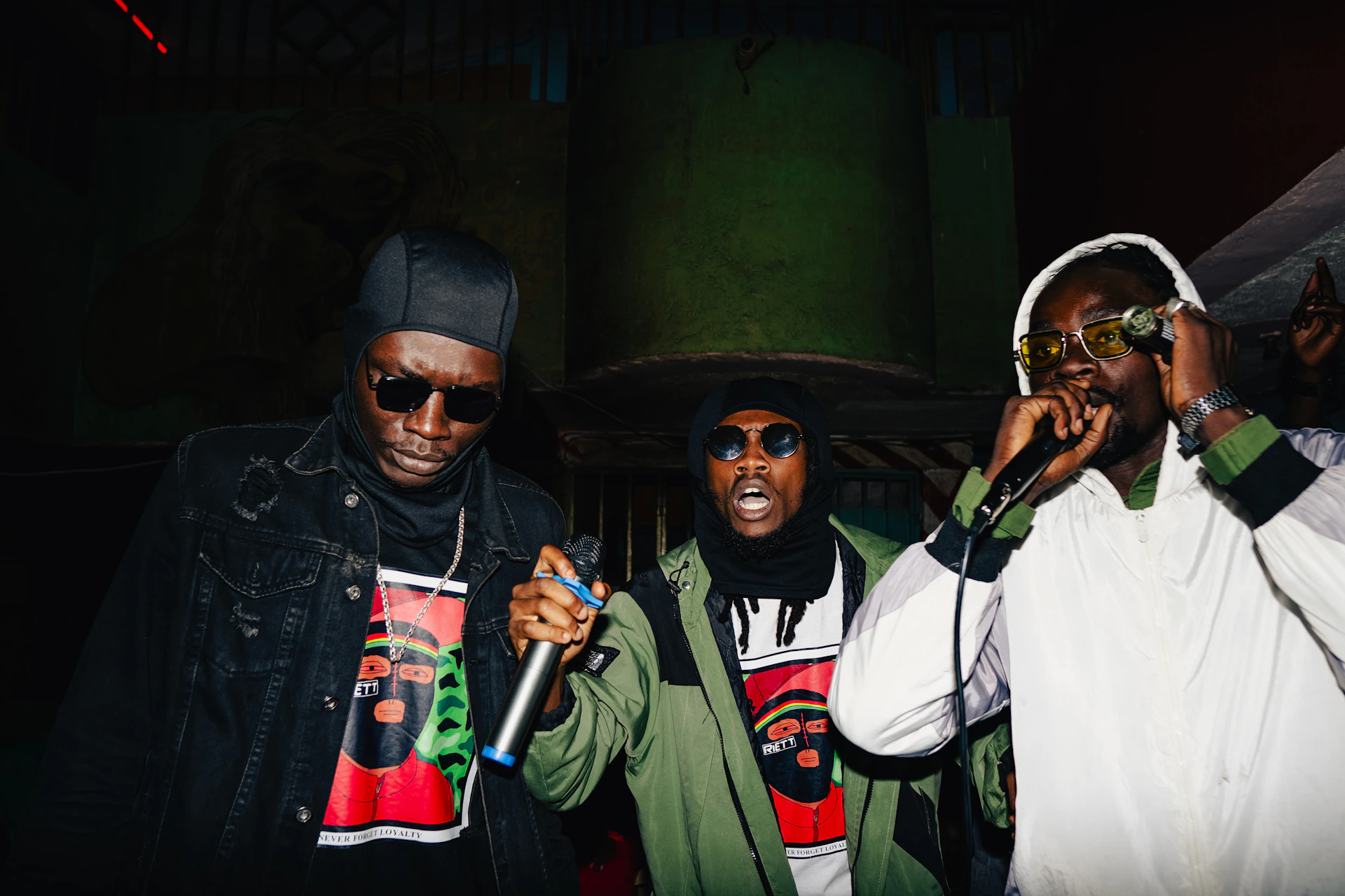 Three men performing music on stage