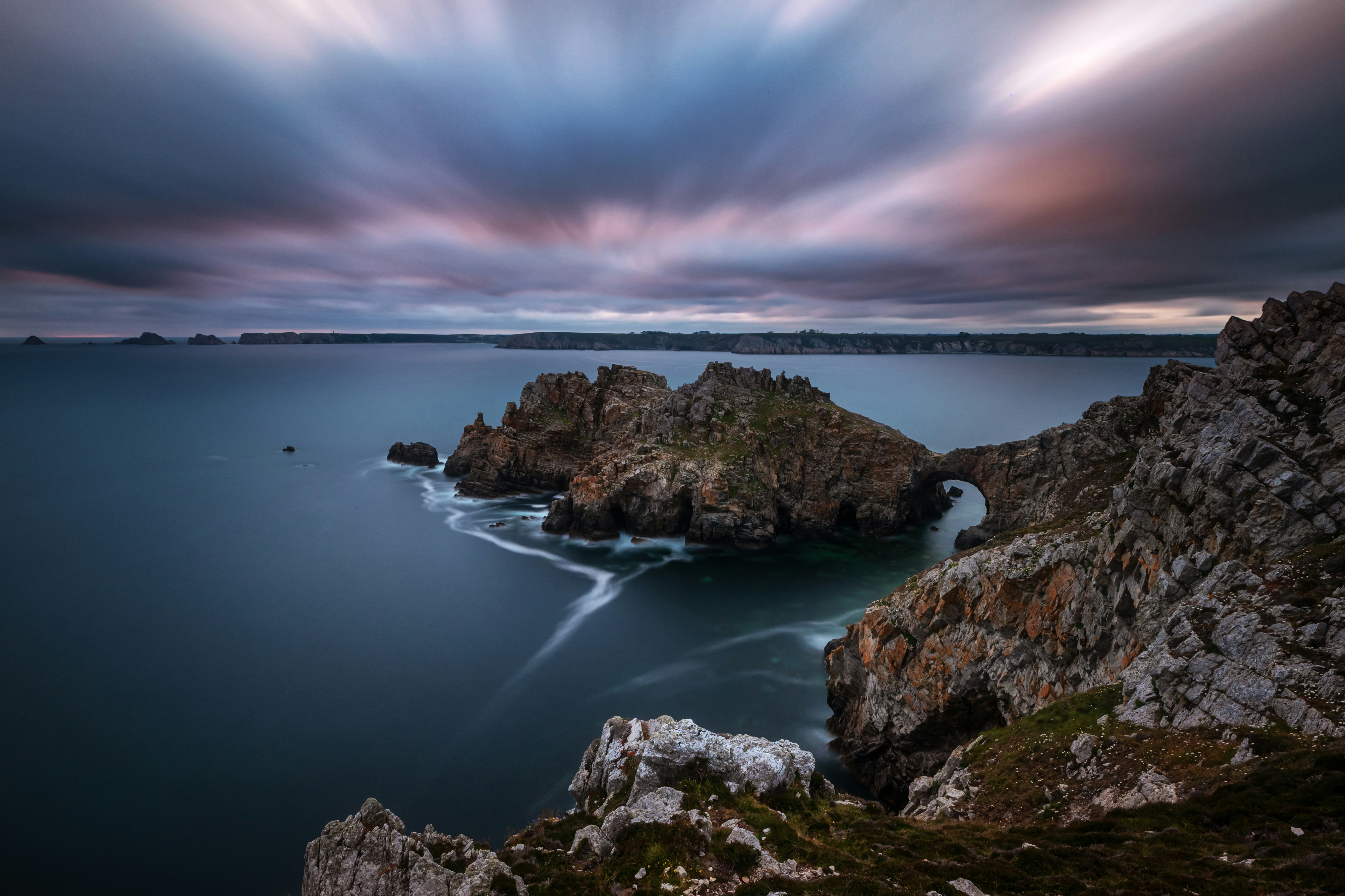 Dramatic ocean seascape with rocky coastline at dusk