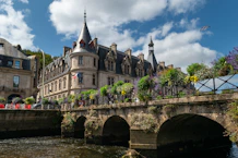 Historic building with arched bridge over river