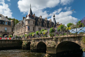 Historic building with arched bridge over river