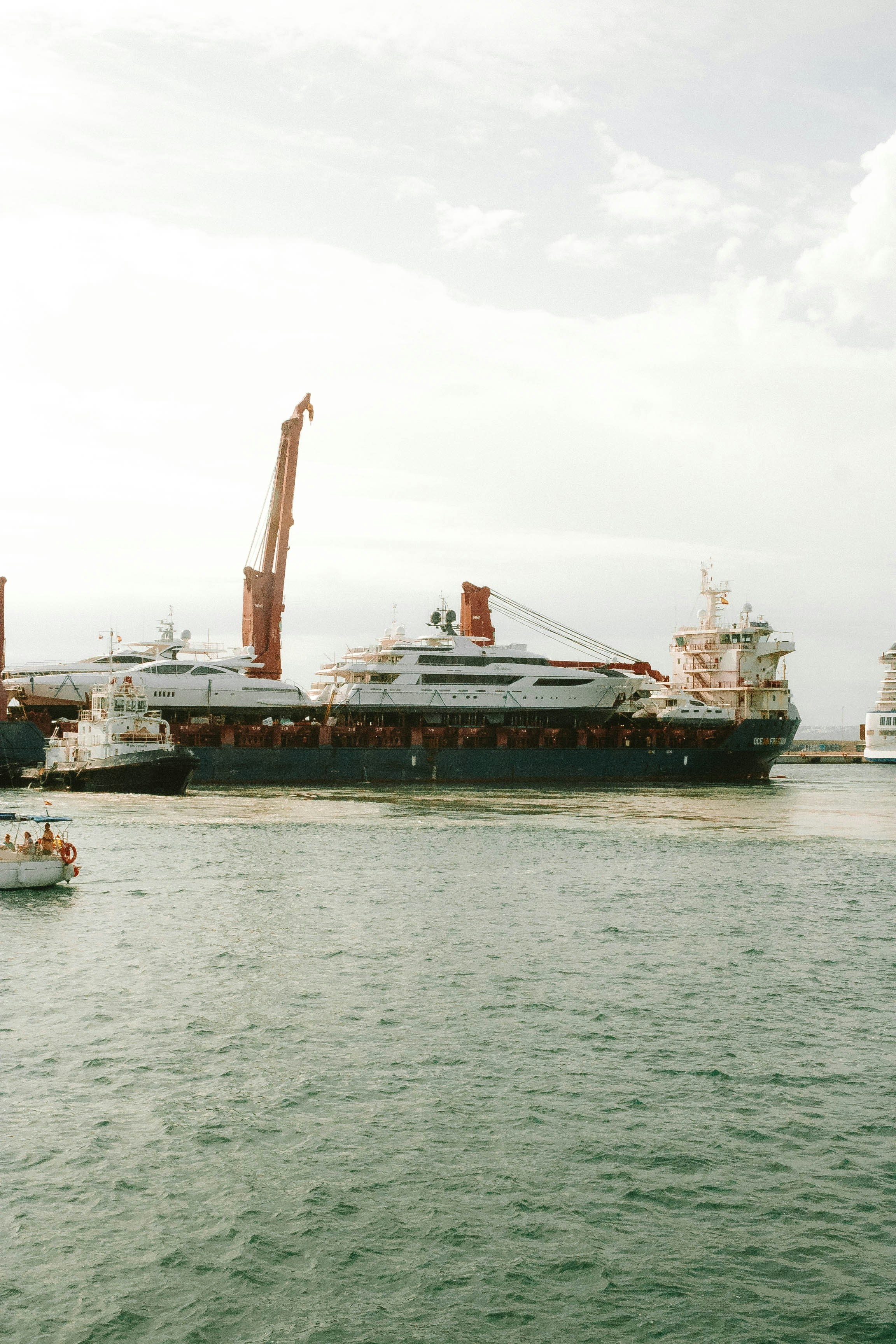 Large cargo ship with crane in a harbor