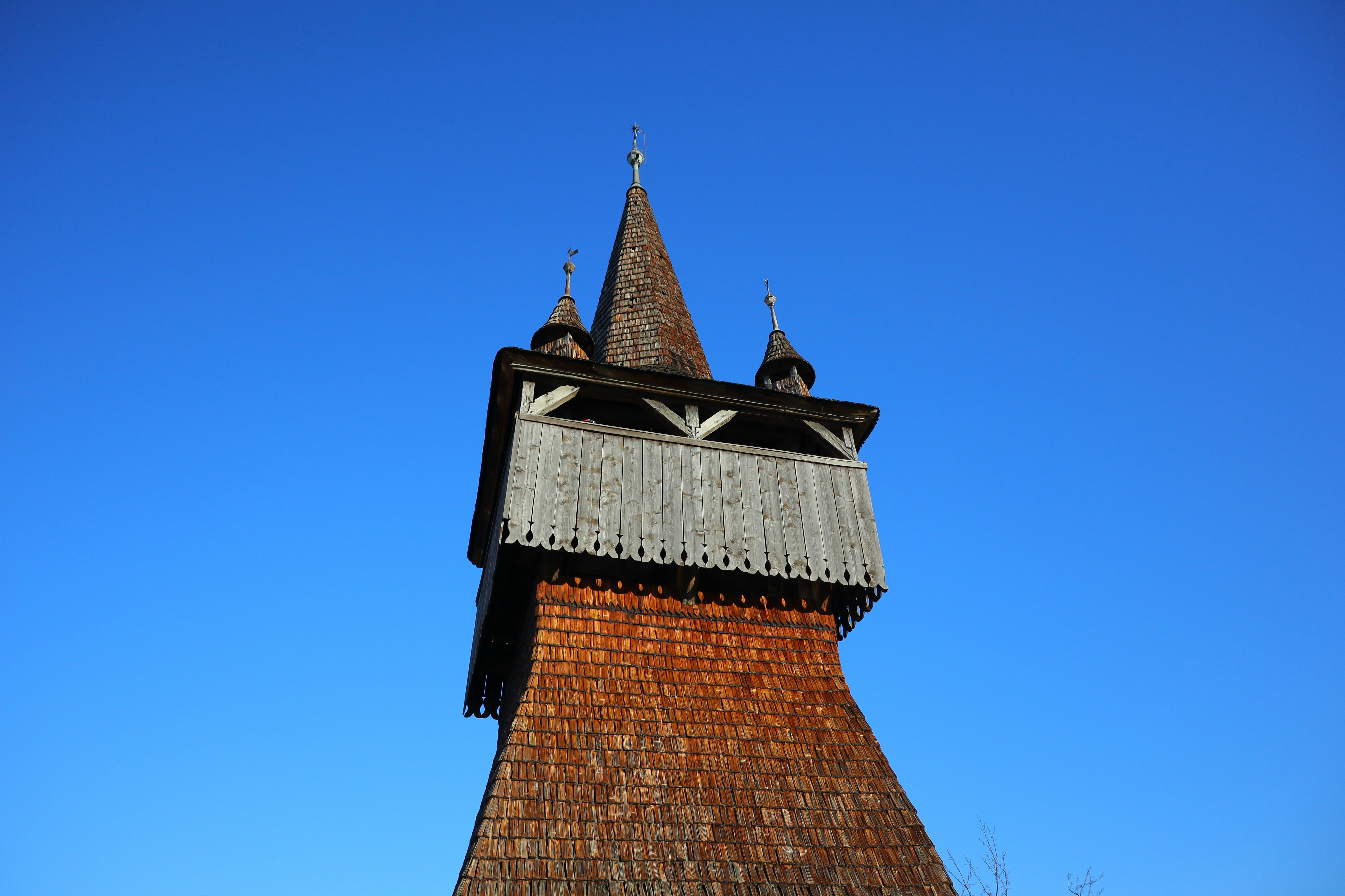 Wooden church tower against a clear blue sky