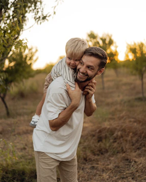 Father giving his son a piggyback ride outdoors
