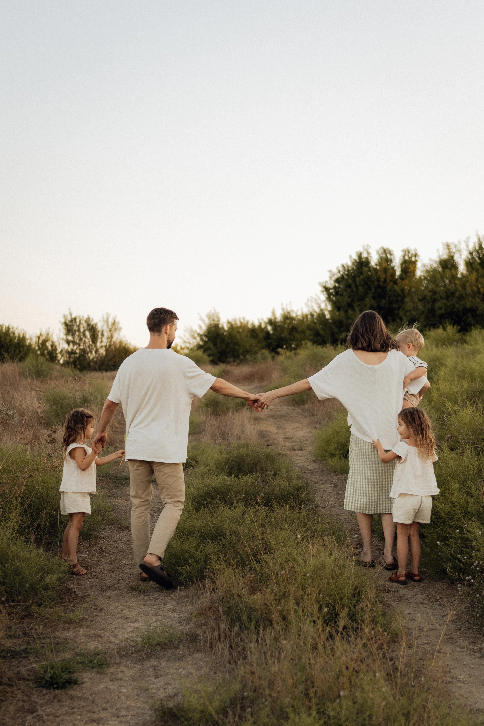 A family walking up a grassy hill