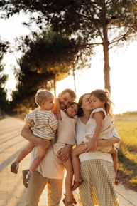 Family embracing outdoors during golden hour