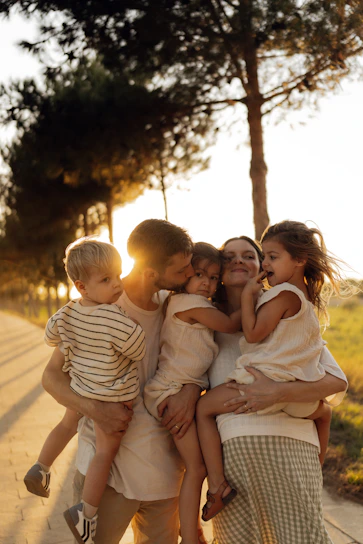 Family embracing during a golden hour sunset.