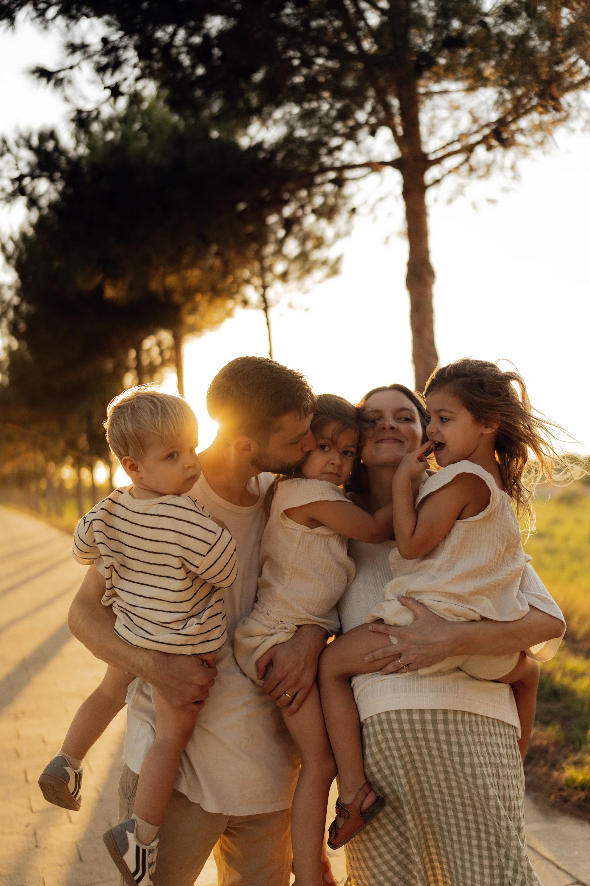 Family embracing during a golden hour sunset.