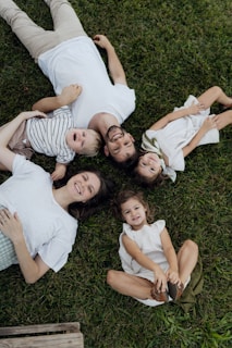 A happy family lying on the grass together