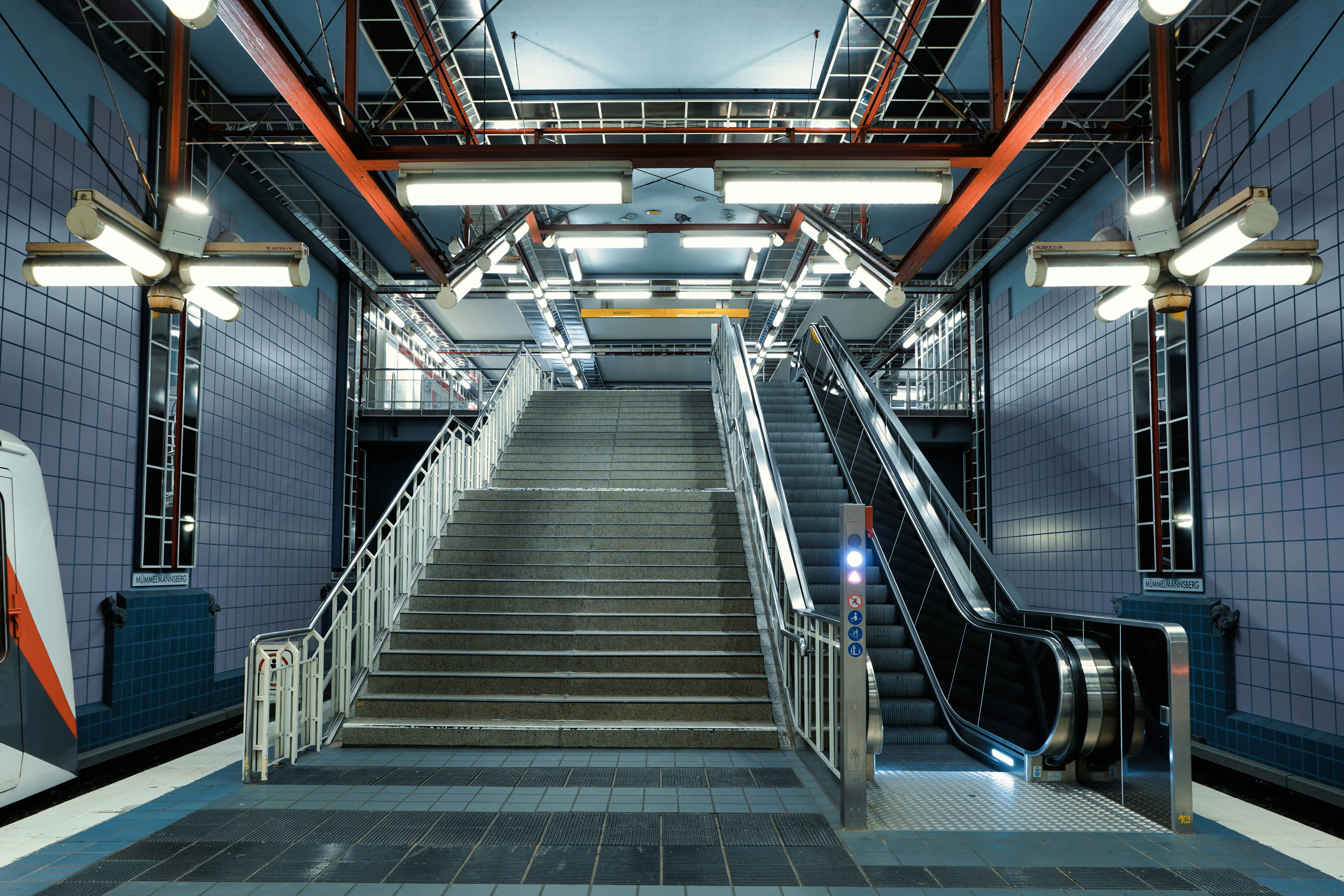 Modern subway station with escalators and stairs.