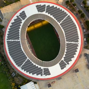 Aerial view of a stadium with solar panels on the roof.