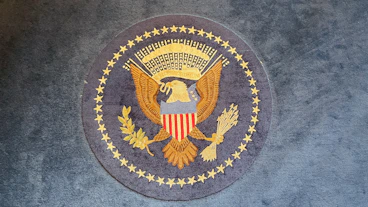 The great seal of the united states on a rug.