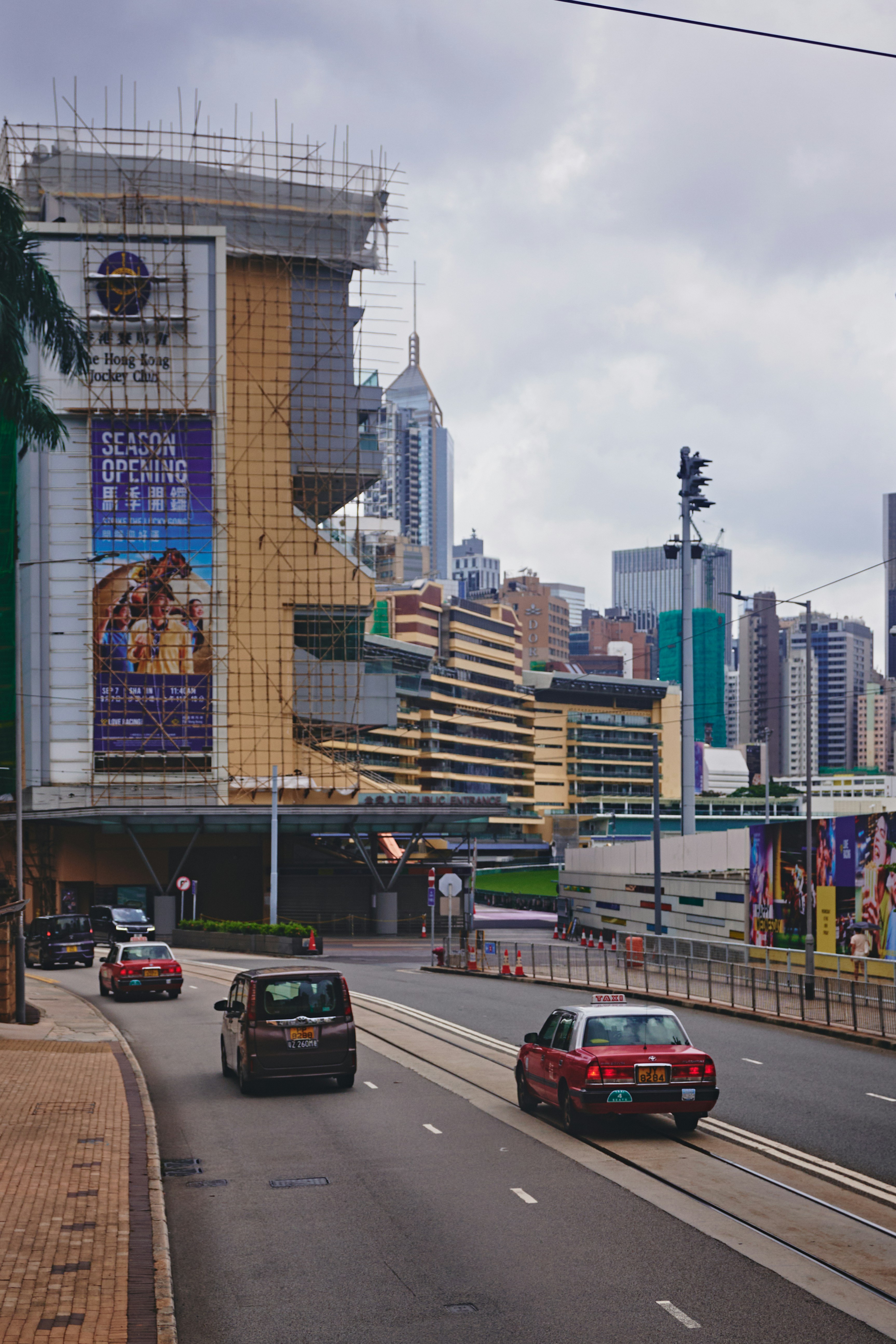 Cars on a city street with buildings under construction.