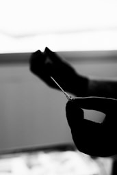 Close-up of a gloved hand holding a syringe