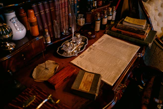 Old desk with books, inkwell, and papers