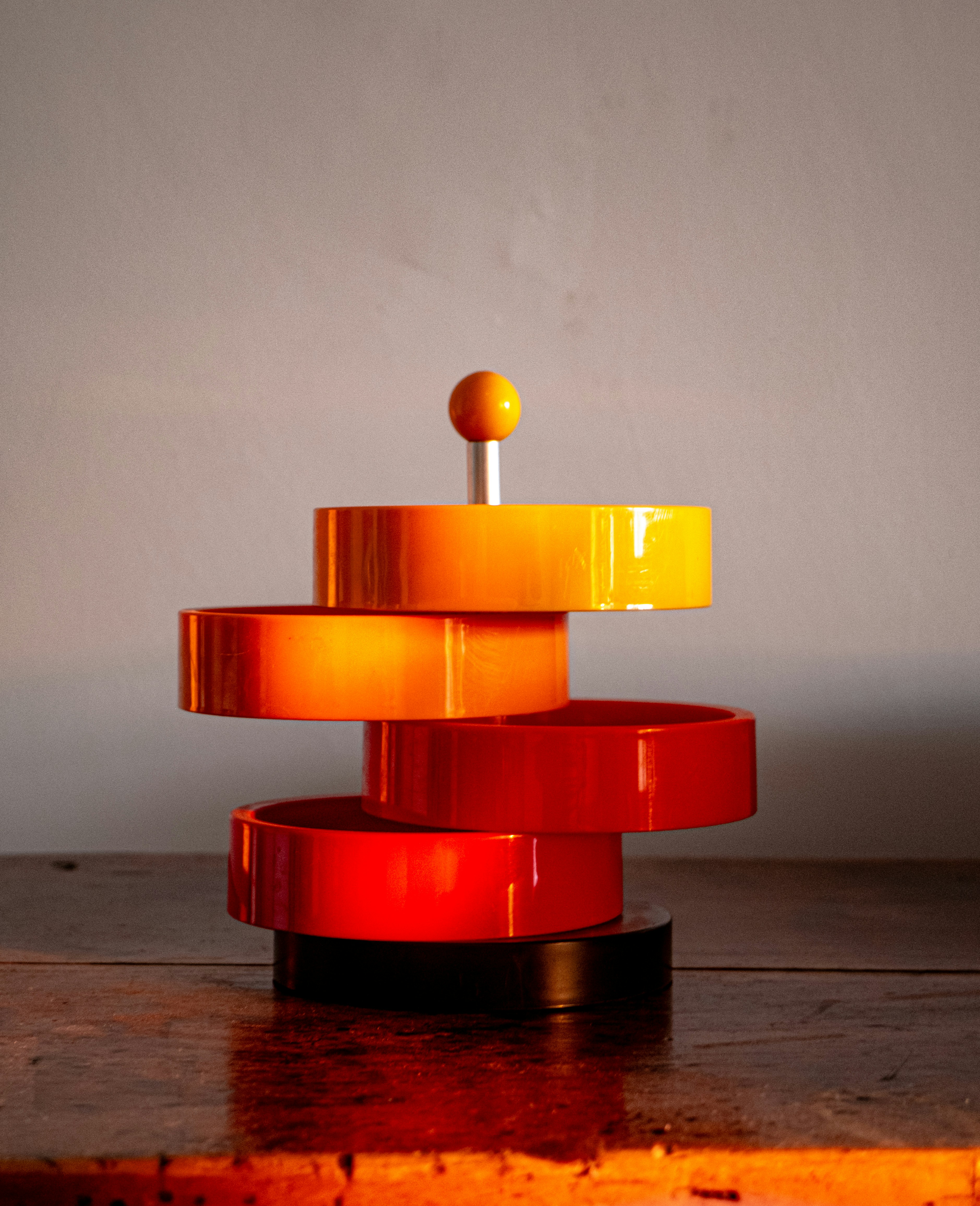 Stack of colorful serving dishes on a wooden surface