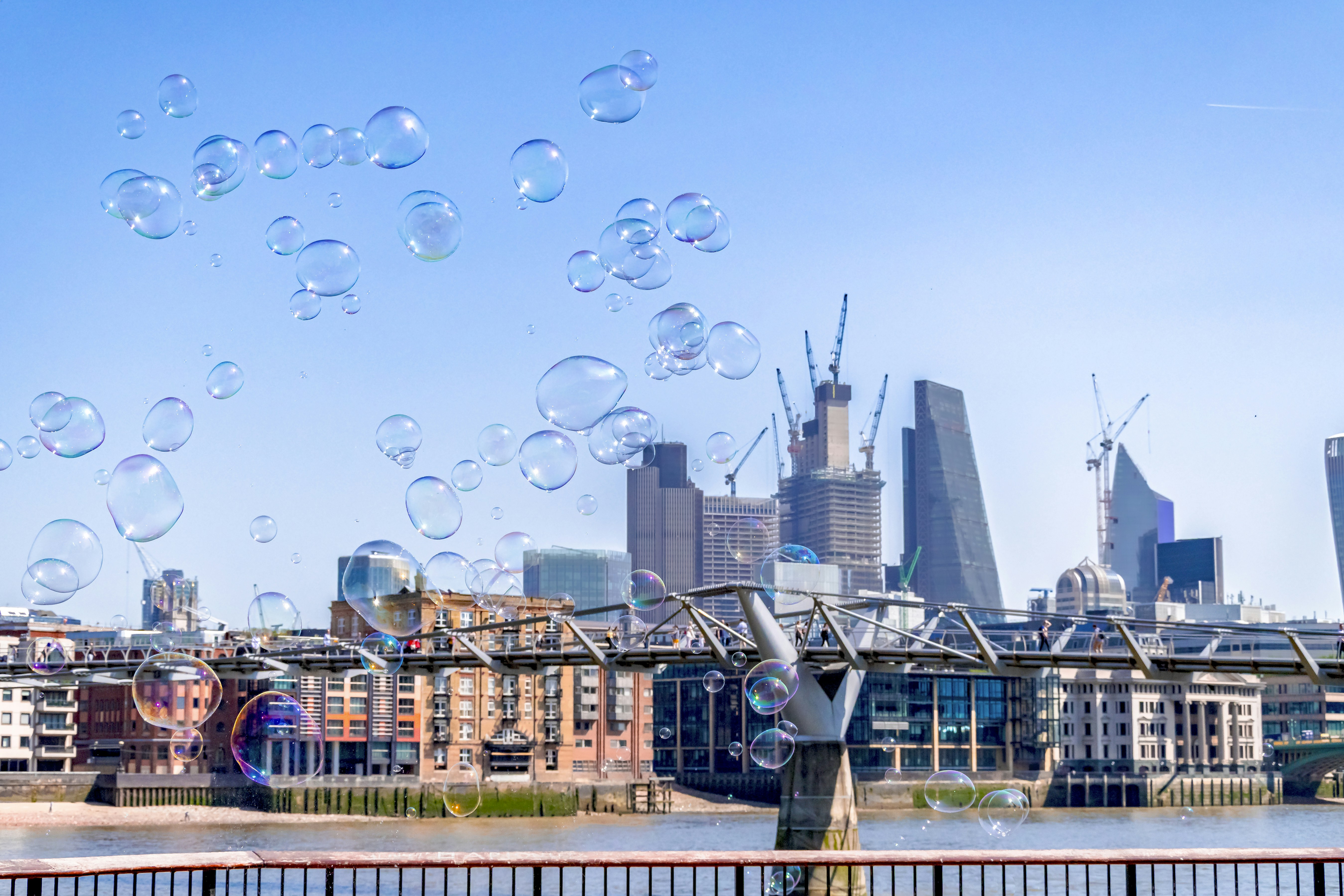 Bubbles float over a cityscape with modern buildings.