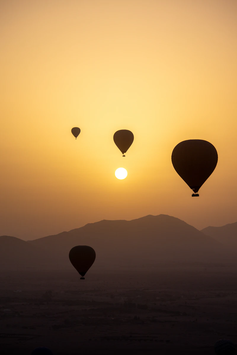 Hot air balloons in the sky at sunrise near Marrakech