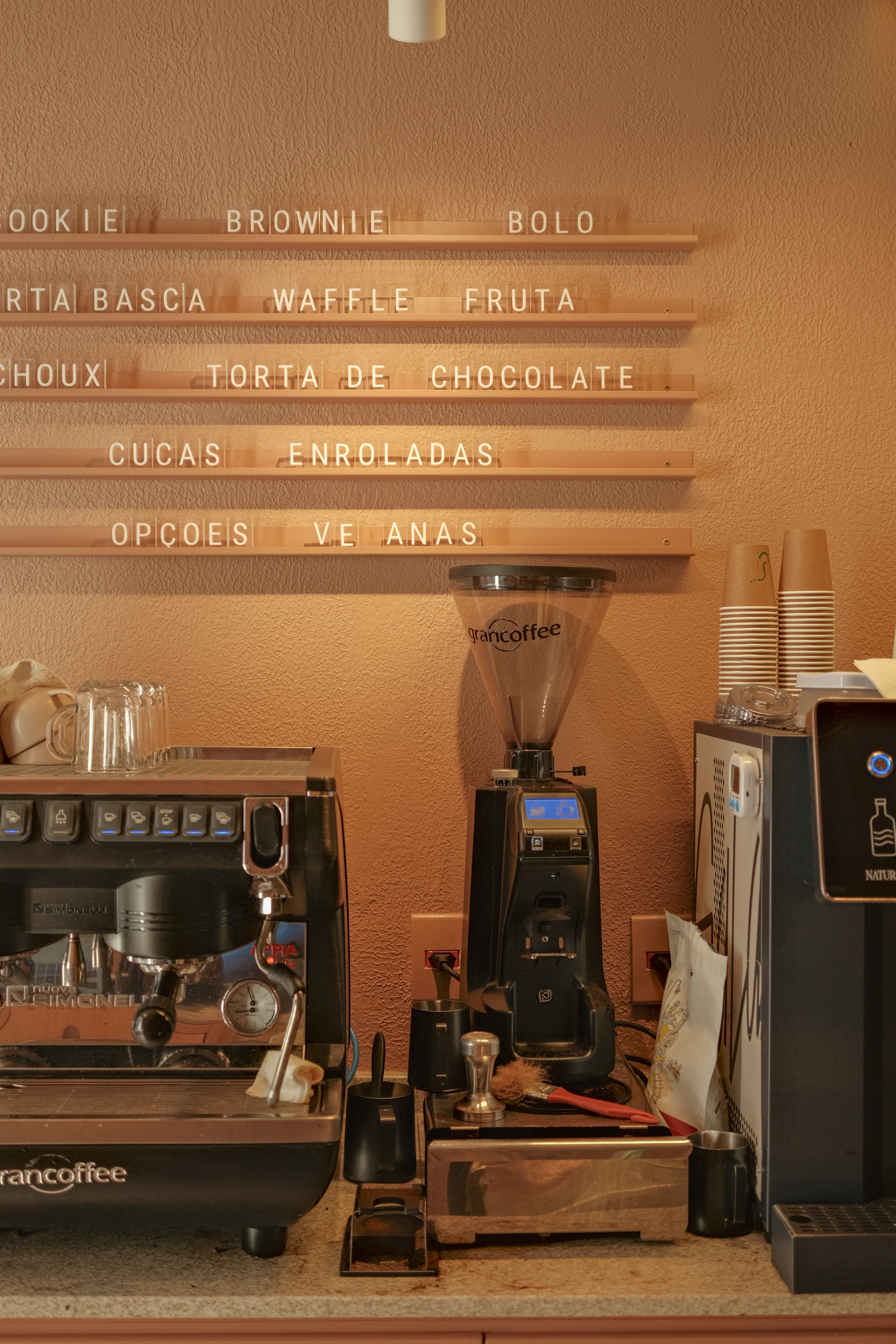 Coffee shop counter with menu board and espresso machine