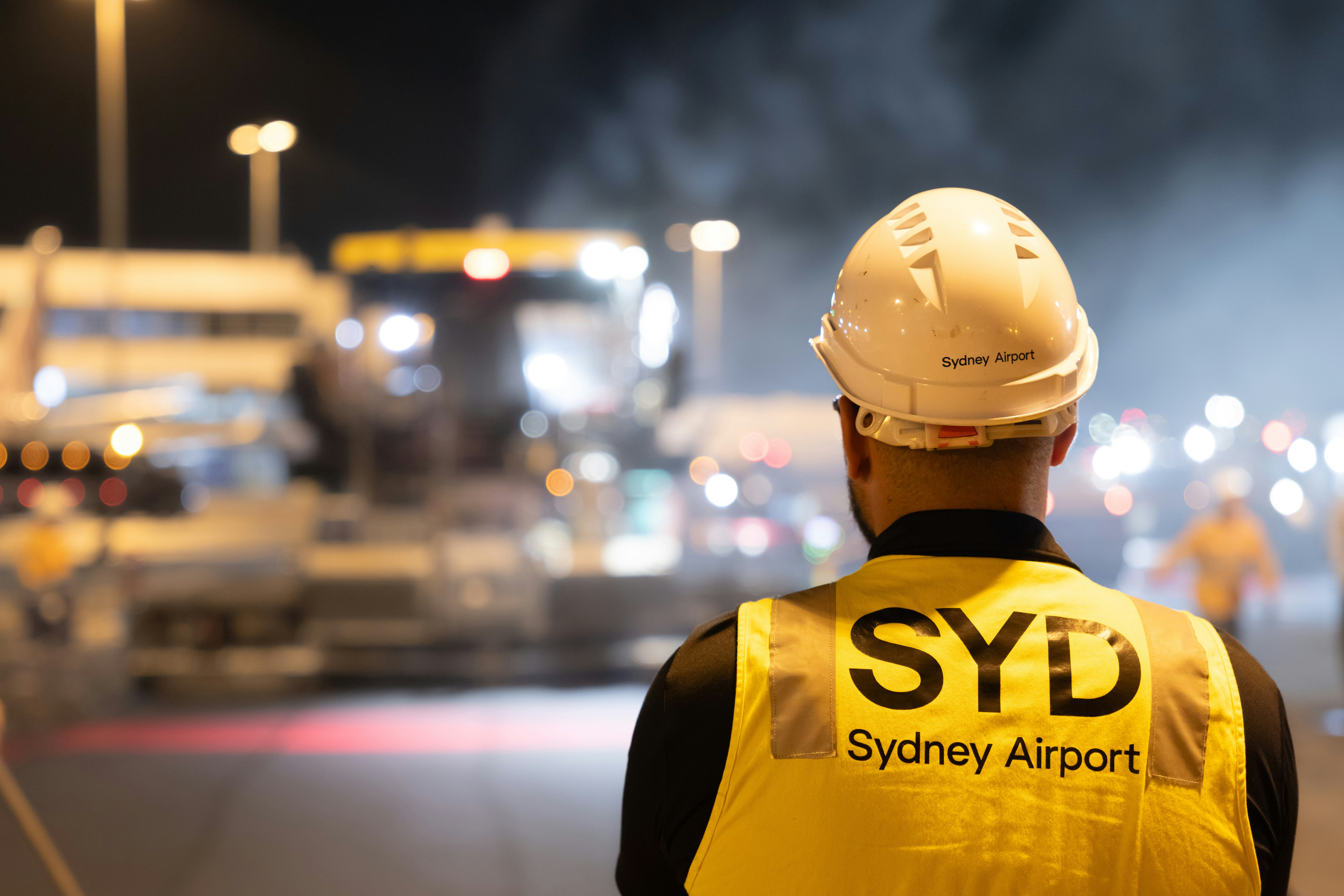 Airport worker in safety vest at night