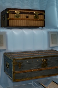 Two vintage trunks displayed on shelves