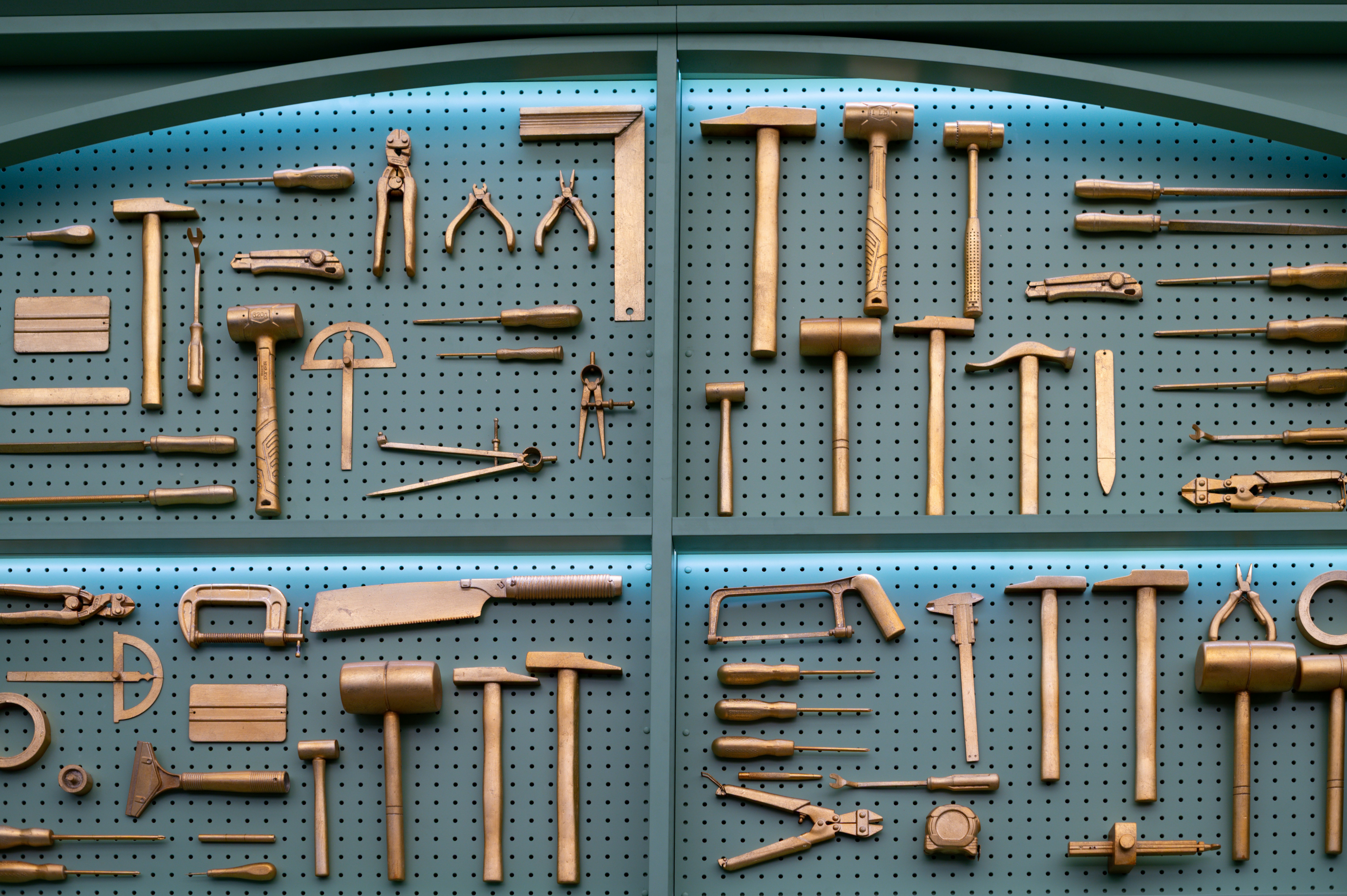 Collection of various brass woodworking tools displayed neatly.