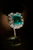 Emerald and diamond ring on display