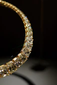 Close-up of a diamond and gold necklace.