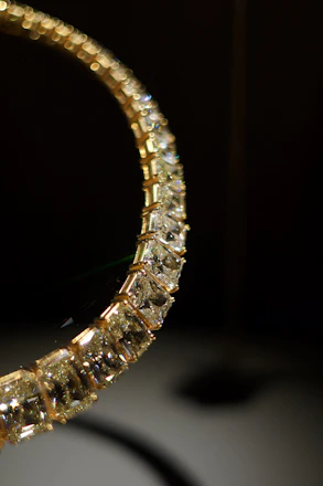 Close-up of a diamond and gold necklace.