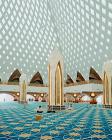 Interior of a modern mosque with patterned carpet and ceiling
