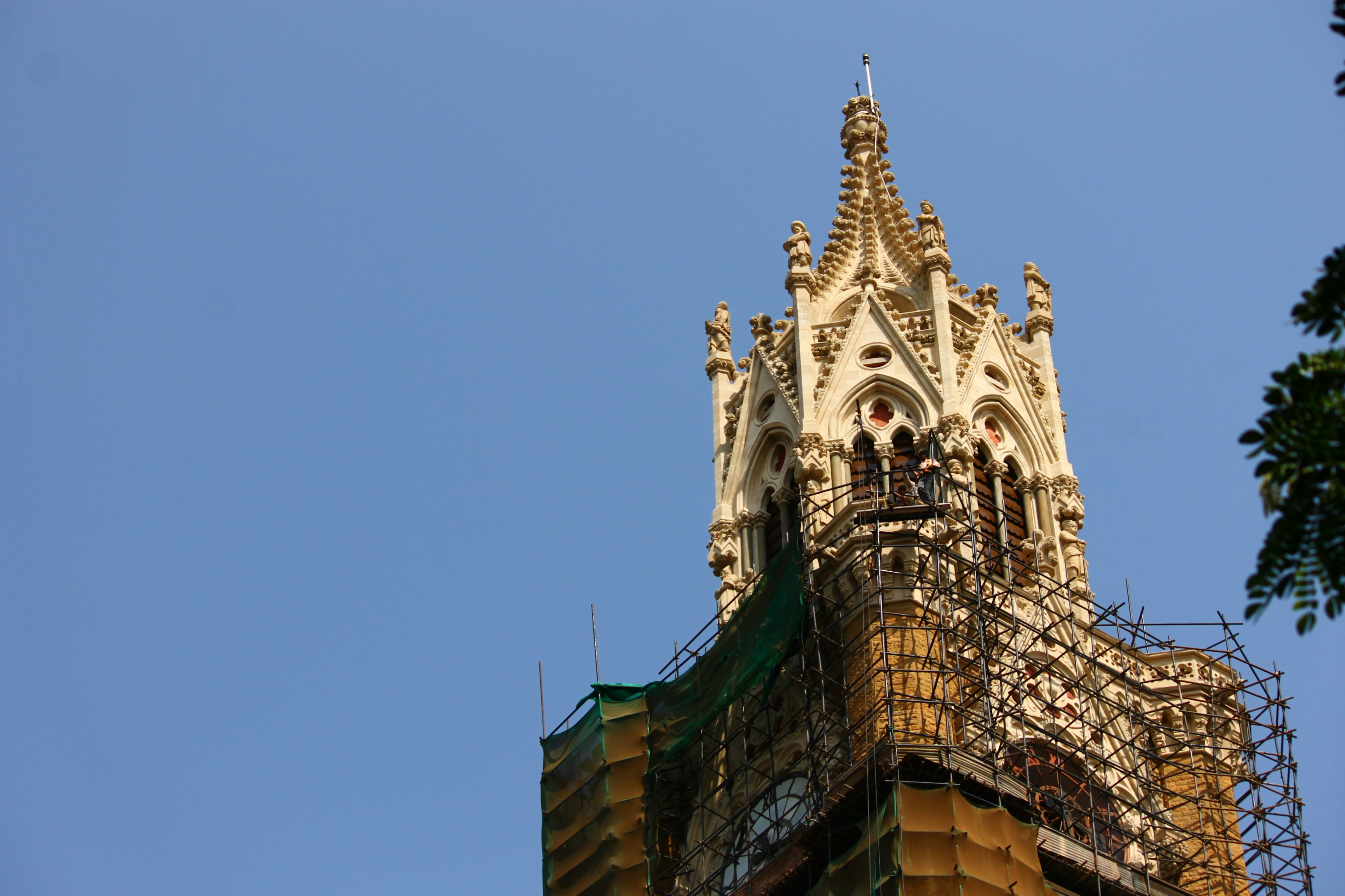Ornate gothic tower against a clear blue sky